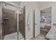 Walk-in shower with glass door, towel hook, and view into the bedroom at 11332 Westbranch Pkwy, Davidson, NC 28036