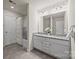 Bathroom featuring double vanity, granite countertop, white cabinets, and a shower-tub combo at 11332 Westbranch Pkwy, Davidson, NC 28036