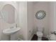 Half bath featuring pedestal sink, decorative mirror, and dark wood floors at 11332 Westbranch Pkwy, Davidson, NC 28036