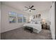 Bedroom featuring ceiling fan, bench, and three windows for natural light at 11332 Westbranch Pkwy, Davidson, NC 28036