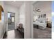 Entryway with coat hooks, bench, and view into the bedroom with ceiling fan at 11332 Westbranch Pkwy, Davidson, NC 28036
