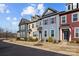 Street view of inviting townhomes with colorful exteriors, manicured lawns, and a peaceful community setting at 11332 Westbranch Pkwy, Davidson, NC 28036