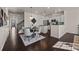 Open-concept kitchen and dining area with hardwood floors and modern stainless steel appliances at 11332 Westbranch Pkwy, Davidson, NC 28036