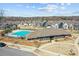 Community pool with clubhouse and surrounding homes in a well-maintained neighborhood at 11332 Westbranch Pkwy, Davidson, NC 28036