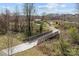 Picturesque greenway trail with a wooden bridge, perfect for outdoor strolls at 11332 Westbranch Pkwy, Davidson, NC 28036