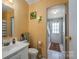 Practical bathroom with a sink, toilet, and doorway to the laundry area at 114 Tr Foster Rd, Kings Mountain, NC 28086