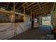 Interior view of horse stalls inside barn with gated entrances at 114 Tr Foster Rd, Kings Mountain, NC 28086