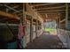 Interior view of horse stalls inside barn with American flag at 114 Tr Foster Rd, Kings Mountain, NC 28086