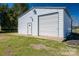 Metal outbuilding with large roll-up door on a grassy lot at 114 Tr Foster Rd, Kings Mountain, NC 28086