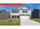 Charming two-story home boasting a well-manicured lawn and a classic facade in a tranquil neighborhood at 117 Way Cross Ln, Troutman, NC 28166