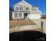 Charming two-story home featuring a two-car garage and neutral-colored siding with stone accents at 121 Goorawing Ln, Mooresville, NC 28115