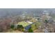 An aerial view of a residential neighborhood with tree coverage and a house with a long driveway at 1263 Waterford Dr, Hickory, NC 28602
