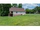 The backyard has a grassy lawn sloping away from the house at 1263 Waterford Dr, Hickory, NC 28602
