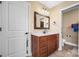 Bathroom featuring wooden vanity with marble top, and view into an adjacent room at 1263 Waterford Dr, Hickory, NC 28602