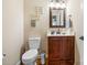 Functional half-bathroom featuring a stylish vanity, toilet, and decorative wall hangings at 1263 Waterford Dr, Hickory, NC 28602