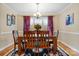 Bright dining room with wooden table, six chairs, decorative rug, and a large window at 1263 Waterford Dr, Hickory, NC 28602