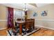 Cozy dining room with a chandelier, a large window with curtains, and wooden floors at 1263 Waterford Dr, Hickory, NC 28602