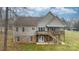 Back exterior of two-story home with deck and stairs in backyard with grass at 1263 Waterford Dr, Hickory, NC 28602