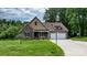 Two-story home featuring stone and shingle siding, attached two-car garage, and a manicured front lawn at 1263 Waterford Dr, Hickory, NC 28602