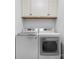 Convenient laundry area with a modern washer and dryer set and overhead storage cabinets at 1263 Waterford Dr, Hickory, NC 28602