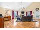 Bright living room features a stone fireplace, vaulted ceilings, and hardwood floors at 1263 Waterford Dr, Hickory, NC 28602