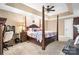 Bright main bedroom featuring a four-poster bed, tray ceiling, work space, and neutral decor at 1263 Waterford Dr, Hickory, NC 28602