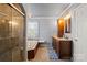 Bathroom with jetted tub, large vanity, and a separate glass door shower at 12836 Harvest Time Ct, Charlotte, NC 28278