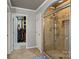 Bathroom featuring a tile shower, walk-in closet, and neutral paint at 12836 Harvest Time Ct, Charlotte, NC 28278