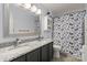 Bathroom featuring a large granite vanity with dual sinks and tub/shower combo at 12836 Harvest Time Ct, Charlotte, NC 28278