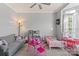 bedroom with hardwood floors, a ceiling fan, large windows and cute furnishings at 12836 Harvest Time Ct, Charlotte, NC 28278