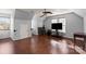 Spacious bonus room featuring hardwood flooring, vaulted ceiling, and multiple windows at 12836 Harvest Time Ct, Charlotte, NC 28278