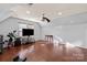 Bonus room features hardwood flooring, a ceiling fan, and natural light at 12836 Harvest Time Ct, Charlotte, NC 28278