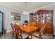 Traditional dining room featuring gray walls, hardwood floors, and a chandelier at 12836 Harvest Time Ct, Charlotte, NC 28278