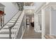 Staircase featuring gray walls, hardwood floors, and views to the front door at 12836 Harvest Time Ct, Charlotte, NC 28278