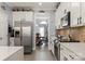 Well-equipped kitchen boasts stainless steel appliances, white countertops and tile backsplash at 12836 Harvest Time Ct, Charlotte, NC 28278