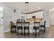 Bright kitchen features island seating, modern lighting, and white cabinetry at 12836 Harvest Time Ct, Charlotte, NC 28278
