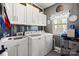 Well-organized laundry room with white cabinets and modern washer and dryer at 12836 Harvest Time Ct, Charlotte, NC 28278