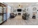 Living room featuring hardwood floors, a fireplace and modern furnishings at 12836 Harvest Time Ct, Charlotte, NC 28278