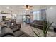 Open living room and kitchen featuring hardwood floors, gray walls, and modern furnishings at 12836 Harvest Time Ct, Charlotte, NC 28278