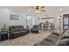 Open living room and kitchen featuring hardwood floors, stainless appliances, and bar top seating at 12836 Harvest Time Ct, Charlotte, NC 28278