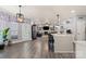 Open concept living space features kitchen, living room with fireplace, and stylish finishes at 12836 Harvest Time Ct, Charlotte, NC 28278