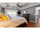 Main bedroom showcases dark grey walls, hardwood flooring, and tray ceiling at 12836 Harvest Time Ct, Charlotte, NC 28278