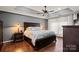 This main bedroom features neutral paint, crown molding, and wood floors at 12836 Harvest Time Ct, Charlotte, NC 28278