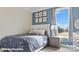 Cozy bedroom with a blue accent wall, plush bedding, and a window offering natural light and a scenic view at 132 Asmodean Ln, Troutman, NC 28166