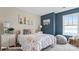 The well-lit bedroom features neutral walls and a full sized bed with floral bedding at 132 Asmodean Ln, Troutman, NC 28166