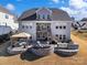 Large backyard featuring stone fire pit, outdoor grill, and patio area at 14230 Morningate St, Huntersville, NC 28078