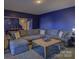 Finished basement with oversized couch, decorative rug, and open floorplan at 14230 Morningate St, Huntersville, NC 28078