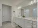 Modern bathroom with double vanity, white countertops, and sleek fixtures at 14230 Morningate St, Huntersville, NC 28078