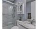 Bathroom featuring marble shower, granite counters, vanity, and cabinetry at 14230 Morningate St, Huntersville, NC 28078