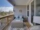 Inviting covered porch with comfortable seating, an outdoor table, and scenic views at 14230 Morningate St, Huntersville, NC 28078